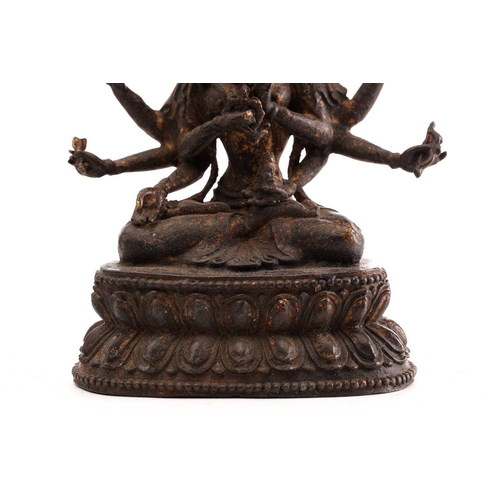 187 - A Chinese bronze figure of Ushnishavijaya, the eight arms each with attribute, beneath three faces, ... 