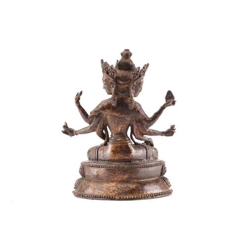 187 - A Chinese bronze figure of Ushnishavijaya, the eight arms each with attribute, beneath three faces, ... 