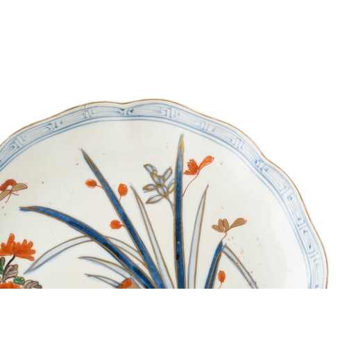 188 - A set of seven Japanese Arita plates, late 19th century, painted with flowers and leaves with butter... 