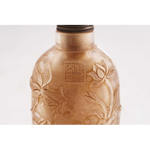 189 - A Chinese moulded glass snuff bottle, relief casrved with a crane and fish with lotus, a square seal... 