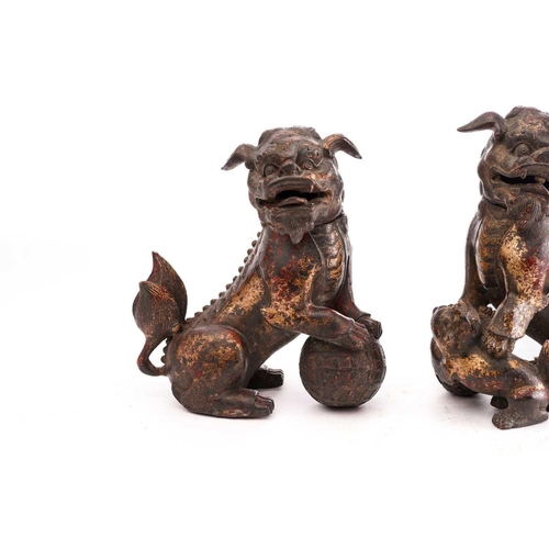 194 - A pair of Chinese bronze censors in the form of temple lions, seated on their haunches, the heads hi... 