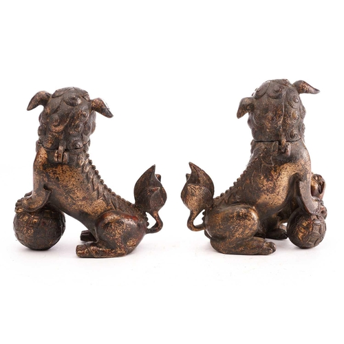 194 - A pair of Chinese bronze censors in the form of temple lions, seated on their haunches, the heads hi... 