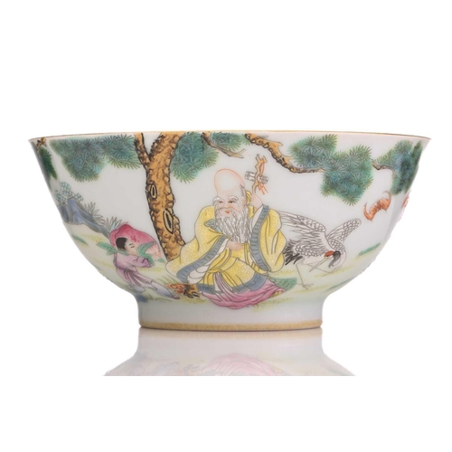 202 - A Chinese porcelain bowl, painted with Shoulao beneath a pine tree with lingzhi, his attendant carry... 