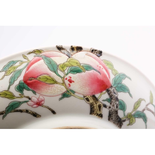 210 - A Chinese porcelain peach dish, painted on both sides with ripe peaches on leafy branches with bats,... 