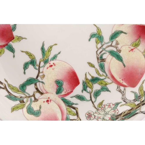 210 - A Chinese porcelain peach dish, painted on both sides with ripe peaches on leafy branches with bats,... 