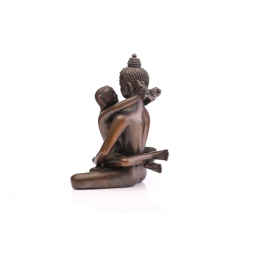 217 - A Tibetan bronze figure of the Buddha & Consort Samantabadra in a loving embrace, the base with a pr... 