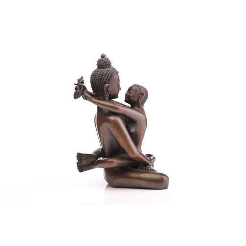 217 - A Tibetan bronze figure of the Buddha & Consort Samantabadra in a loving embrace, the base with a pr... 