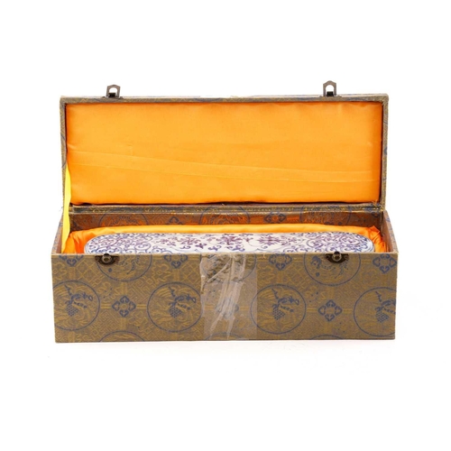 219 - A Chinese porcelain pen box and cover, of rectangular form with rounded ends, the cover painted with... 