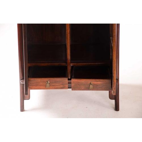 221 - A Chinese Huanghuali tapering two-door cabinet with radiused corners, Qing Dynasty. Each door with f... 