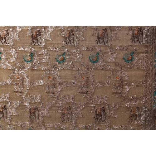 222 - An Indian ivory ground jacquard silk panel with repetitive bands of elephants and birds within an iv... 