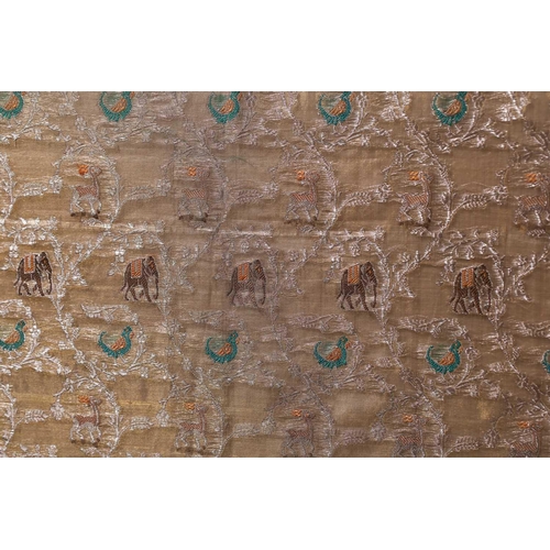 222 - An Indian ivory ground jacquard silk panel with repetitive bands of elephants and birds within an iv... 