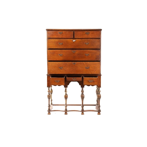 249 - An 18th century oak chest on later stand, the moulded edge top over two short and three long graduat... 