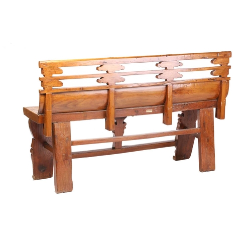 259 - A Chinese elm temple bench, probably late 19th century, with carved double rail back over a thick so... 