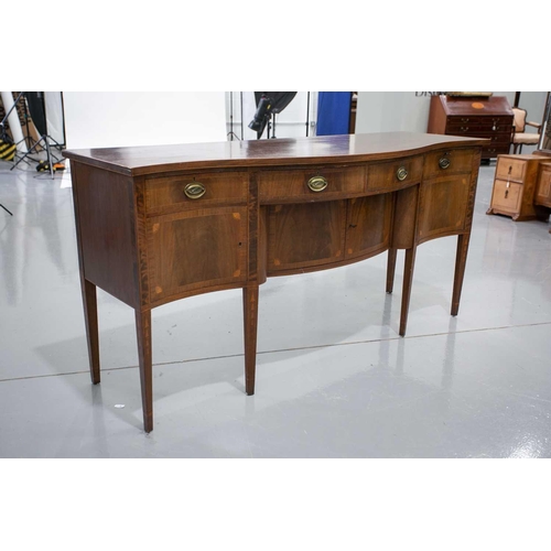 260 - A Friedman Brothers 1929; a George III style inlaid mahogany, serpentine kneehole sideboard with fou... 