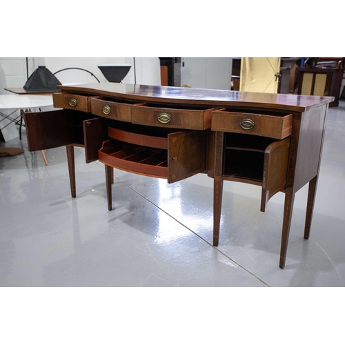 260 - A Friedman Brothers 1929; a George III style inlaid mahogany, serpentine kneehole sideboard with fou... 