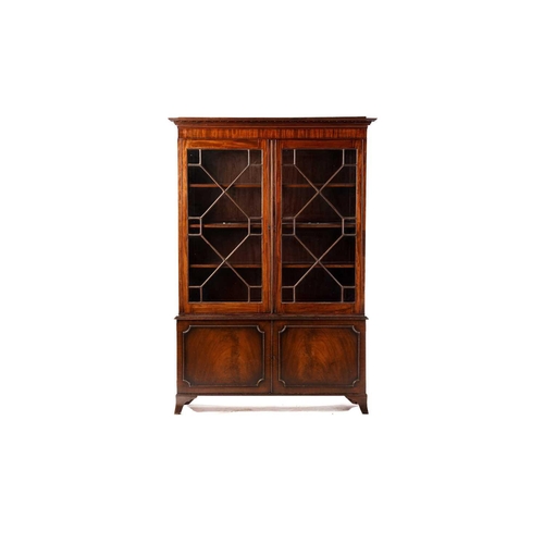 273 - George III mahogany bookcase, on a later stand, the protruding dentil cornice over a pair of astrgal... 