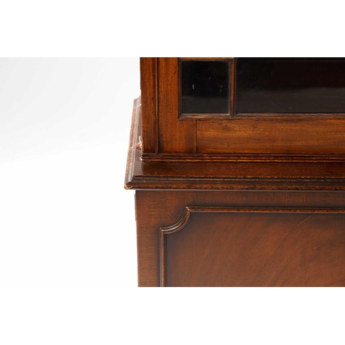 273 - George III mahogany bookcase, on a later stand, the protruding dentil cornice over a pair of astrgal... 