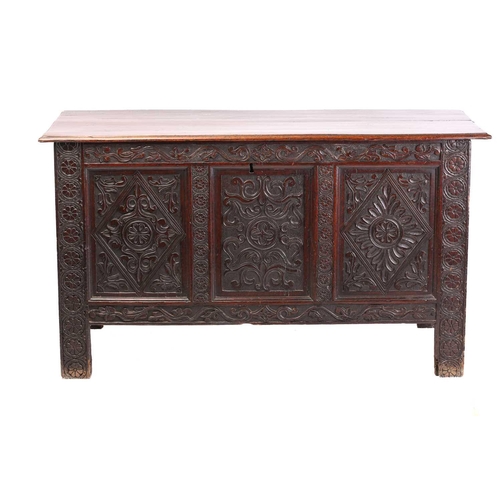 282 - A mid-17th century oak three-panel coffer, with a planked top, the panels and stiles with caved guil... 