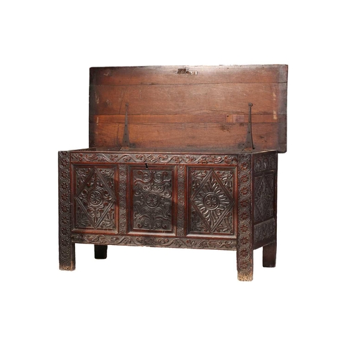 282 - A mid-17th century oak three-panel coffer, with a planked top, the panels and stiles with caved guil... 