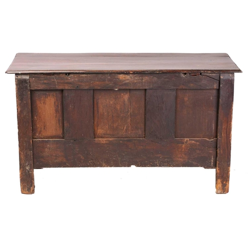 282 - A mid-17th century oak three-panel coffer, with a planked top, the panels and stiles with caved guil... 