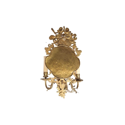 284 - A pair of gilt brass three-sconce girandole with putti surmounts above cartouche-shaped mirror plate... 