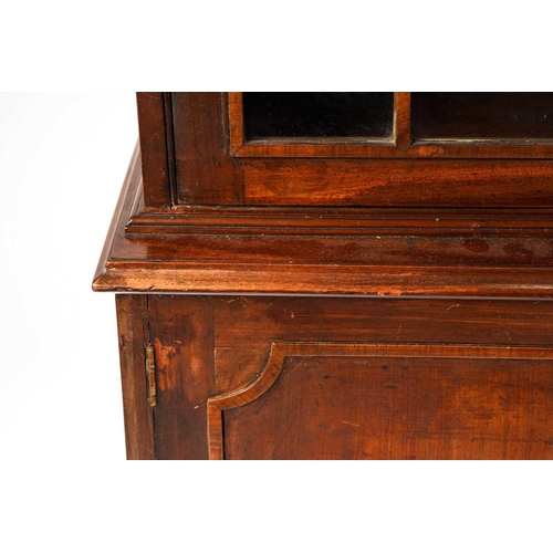 285 - A George III and later mahogany bookcase cabinet, the moulded cornice above a pair of glazed doors w... 