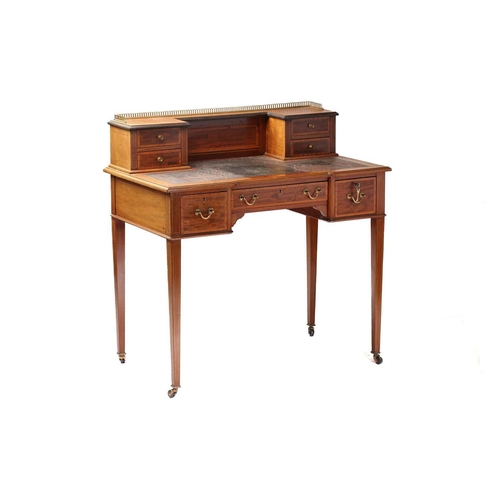 288 - An Edwardian inlaid mahogany Maple & Co, bonheur du jour of inverted breakfront form. The superstruc... 