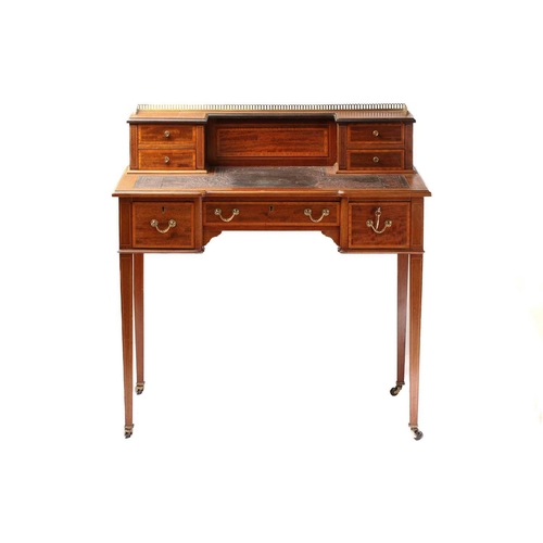 288 - An Edwardian inlaid mahogany Maple & Co, bonheur du jour of inverted breakfront form. The superstruc... 