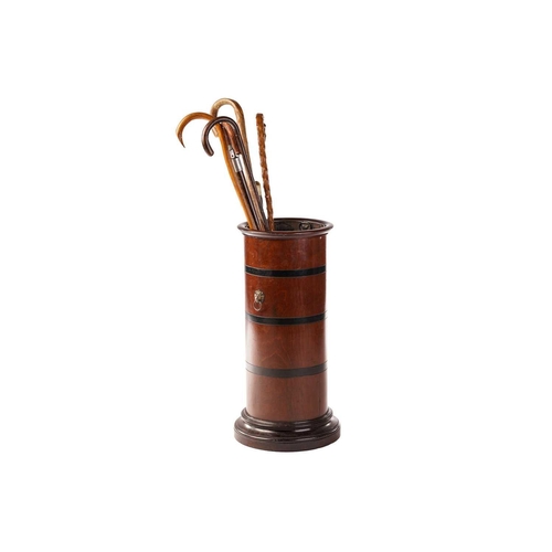 296 - An Edwardian-turned mahogany cylindrical stick stand with moulded rim and foot, the body with contra... 