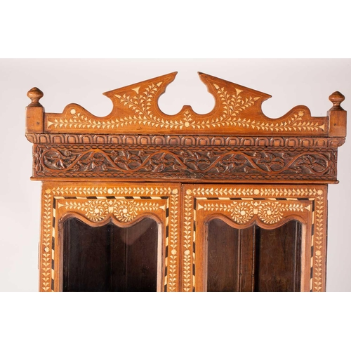 300 - An Anglo-Indian bone and ebony inlaid cabinet, early 20th century, with a shaped broken arch pedimen... 