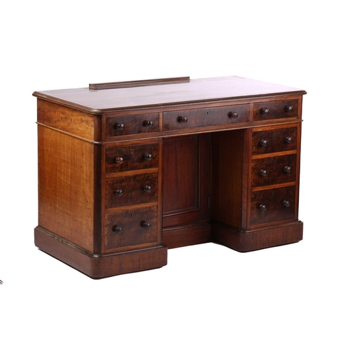 302 - A late Victorian mahogany kneehole pedestal writing desk, the figured top above three frieze drawers... 