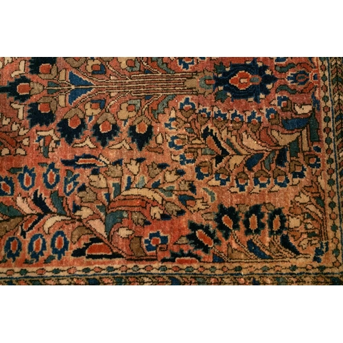 319 - An old Sarouk short runner with sprays of flowers on a pink ground within multiple borders,191 cm x ... 