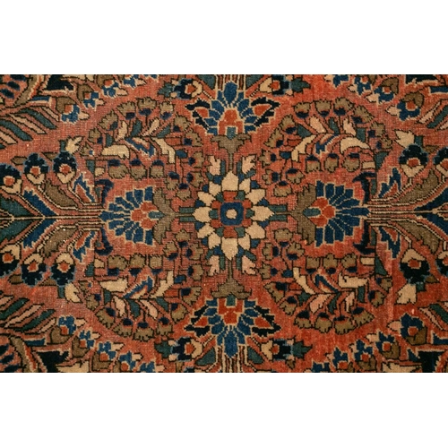 319 - An old Sarouk short runner with sprays of flowers on a pink ground within multiple borders,191 cm x ... 