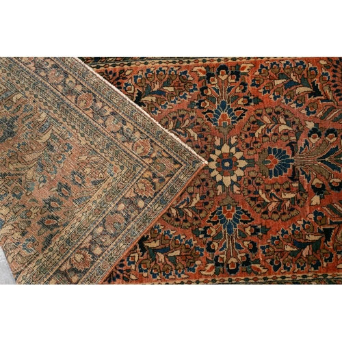 319 - An old Sarouk short runner with sprays of flowers on a pink ground within multiple borders,191 cm x ... 