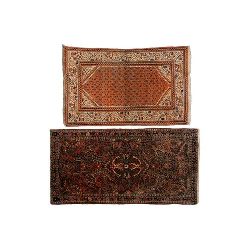 320 - A small Sarouk rug with a distinctive pink ground with a central medallion and sprays of flowers wit... 