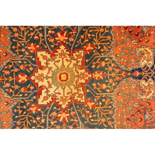 326 - An old Tabriz rug with a central star motif with hanging lanterns and animals and shrubs on crimson ... 