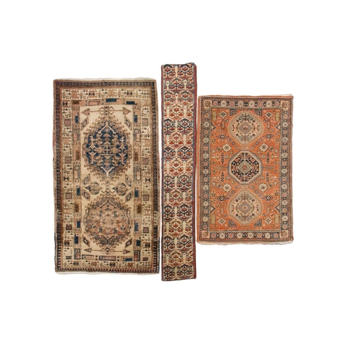 333 - An old possibly North West Persian tribal rug with two lozenges on a faded ivory ground, 165 cm x 90... 