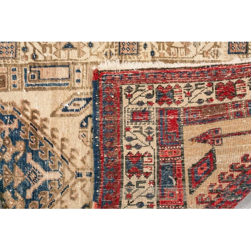 333 - An old possibly North West Persian tribal rug with two lozenges on a faded ivory ground, 165 cm x 90... 