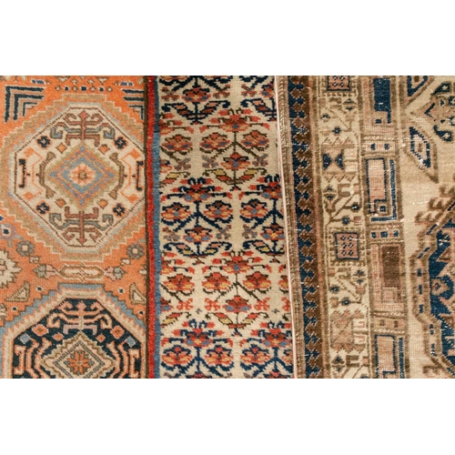 333 - An old possibly North West Persian tribal rug with two lozenges on a faded ivory ground, 165 cm x 90... 