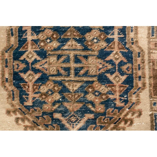 333 - An old possibly North West Persian tribal rug with two lozenges on a faded ivory ground, 165 cm x 90... 