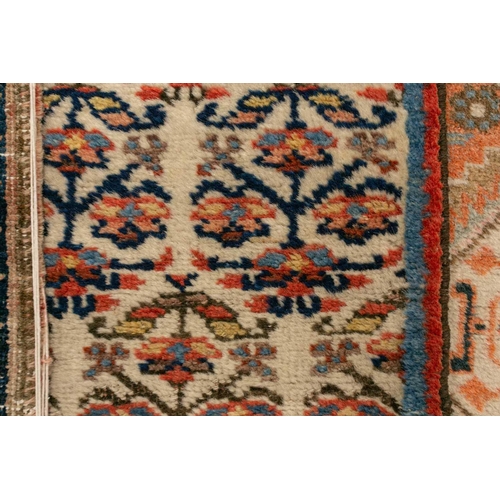 333 - An old possibly North West Persian tribal rug with two lozenges on a faded ivory ground, 165 cm x 90... 