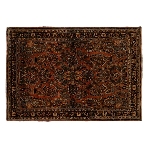 334 - An old sarouk rug with a central medallion and floral sprays on a salmon pink ground. within floral ... 