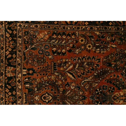 334 - An old sarouk rug with a central medallion and floral sprays on a salmon pink ground. within floral ... 