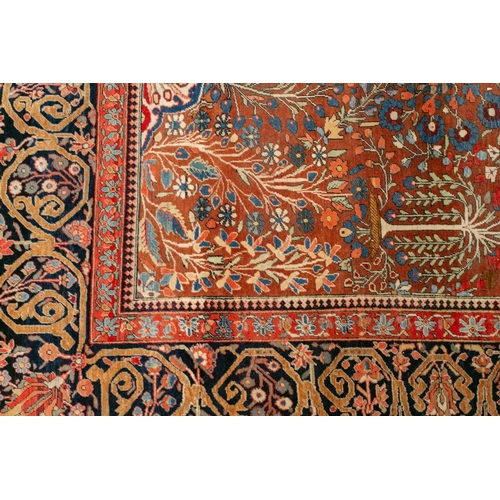 335 - An old Motashemi Kashan rug with a flowering urn issuing from an urn on a brick red ground within a ... 