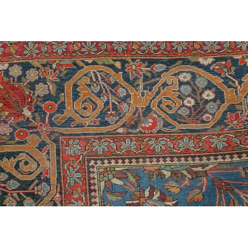 335 - An old Motashemi Kashan rug with a flowering urn issuing from an urn on a brick red ground within a ... 