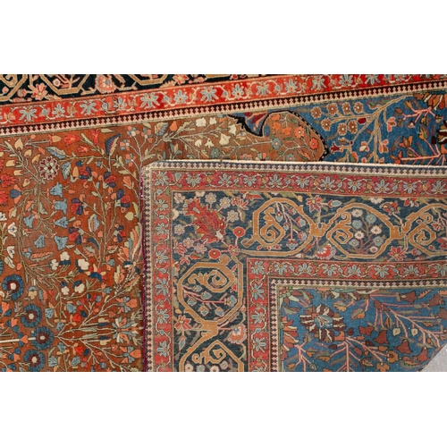 335 - An old Motashemi Kashan rug with a flowering urn issuing from an urn on a brick red ground within a ... 