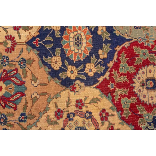 337 - An old probably Kerman rug with an all-over mandorla-shaped tile ground filled with flower heads and... 