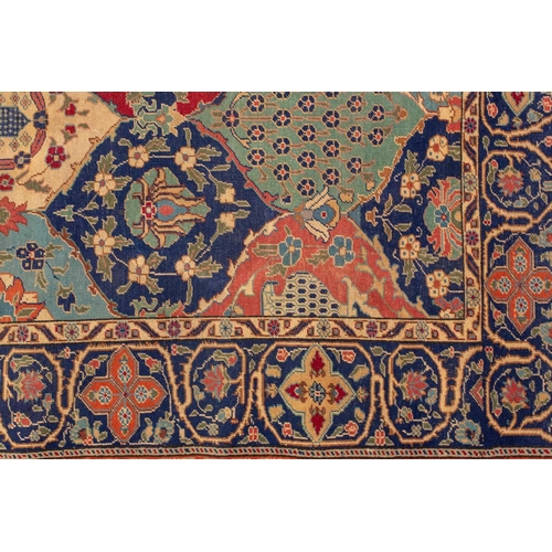 337 - An old probably Kerman rug with an all-over mandorla-shaped tile ground filled with flower heads and... 