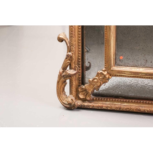 342 - A 19th-century giltwood wall mirror, the scroll carved crest over a beaded frame and protruding rect... 