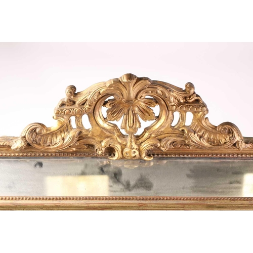 342 - A 19th-century giltwood wall mirror, the scroll carved crest over a beaded frame and protruding rect... 